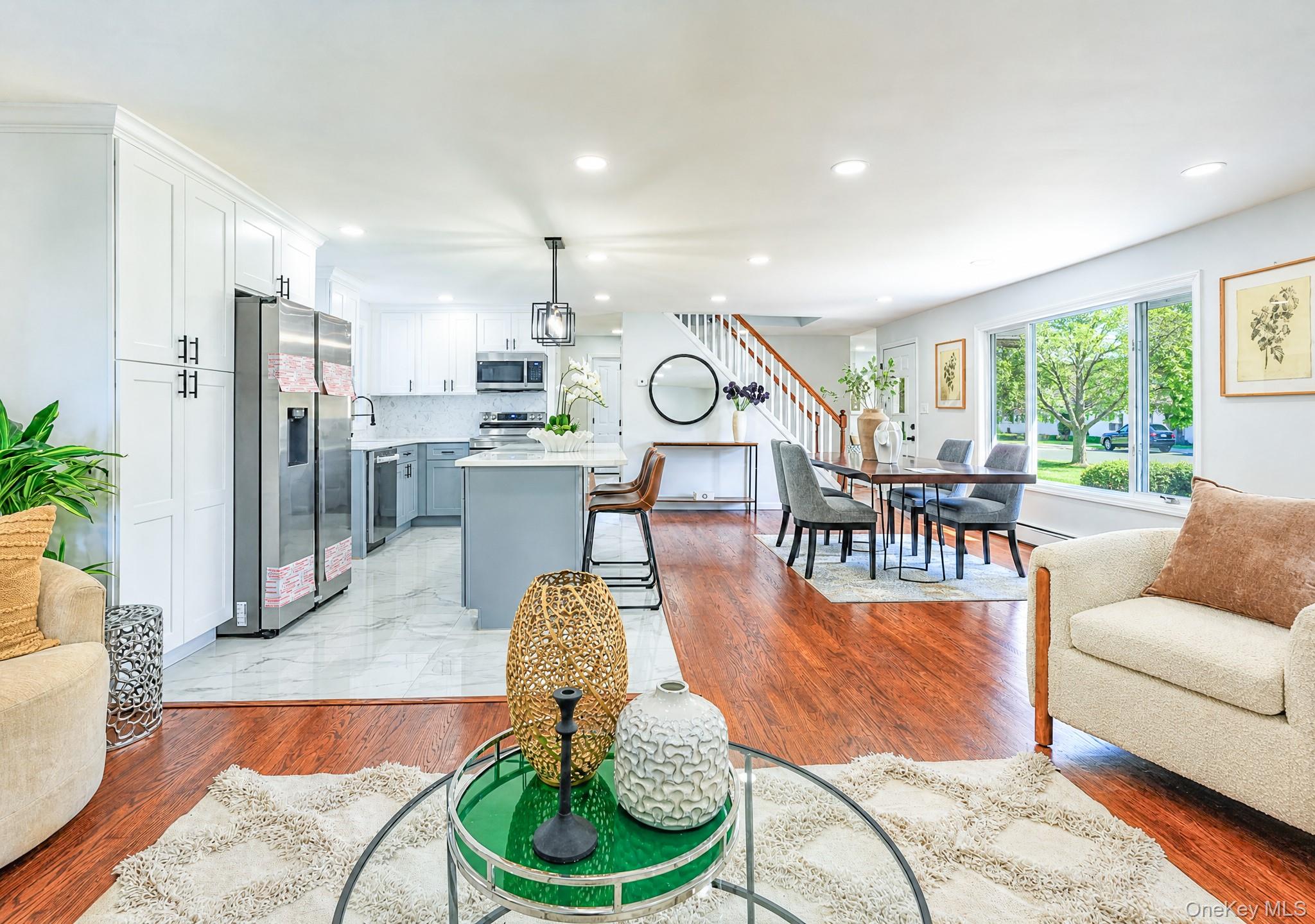 61 Cheshire Road Bethpage, NY 11714 - Photo 6 of 25 Open-concept living space with wood-finish flooring extending into the dining area