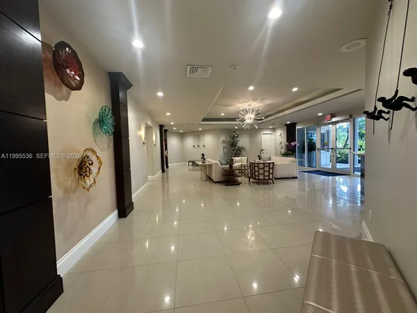 a view of a big room with windows and entryway