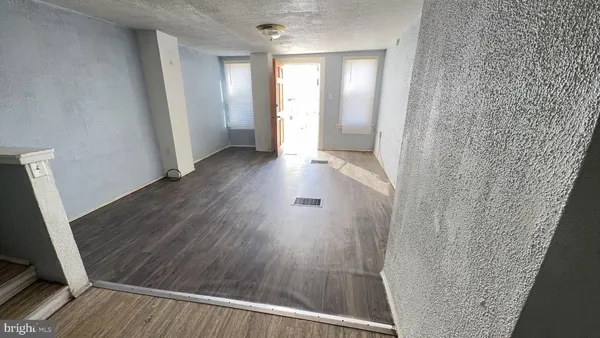 a view of a hallway and wooden floor