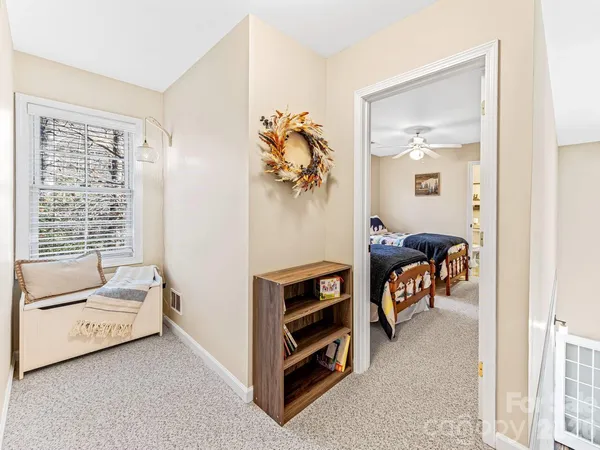 a bedroom with two beds and a chandelier