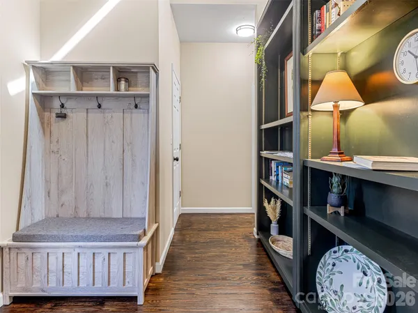 a view of a hallway with wooden floor and closet
