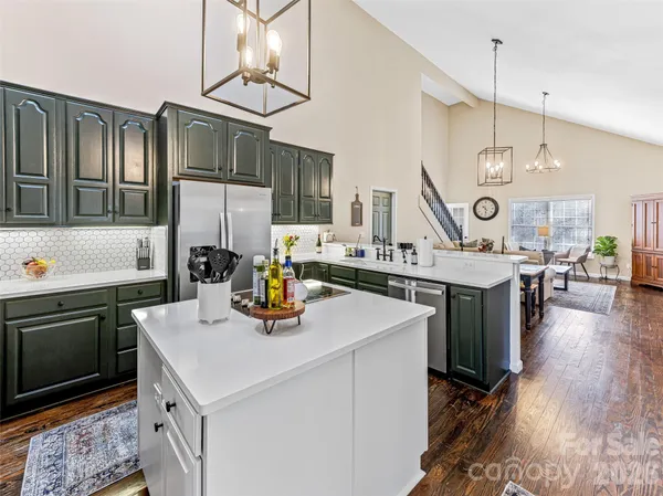 a kitchen with a sink a stove and chairs