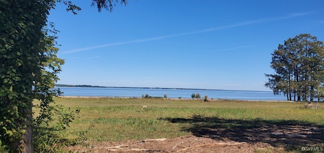 a view of a large body of water with a building in the background