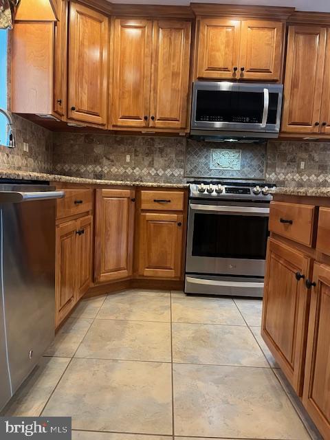 157 Leppo Road Westminster, MD 21158 - Photo 3 of 6 a kitchen with granite countertop a stove a microwave a sink and cabinets