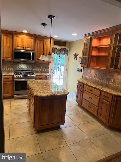 157 Leppo Road Westminster, MD 21158 - Photo 5 of 6 a kitchen with stainless steel appliances granite countertop a stove a sink and a microwave
