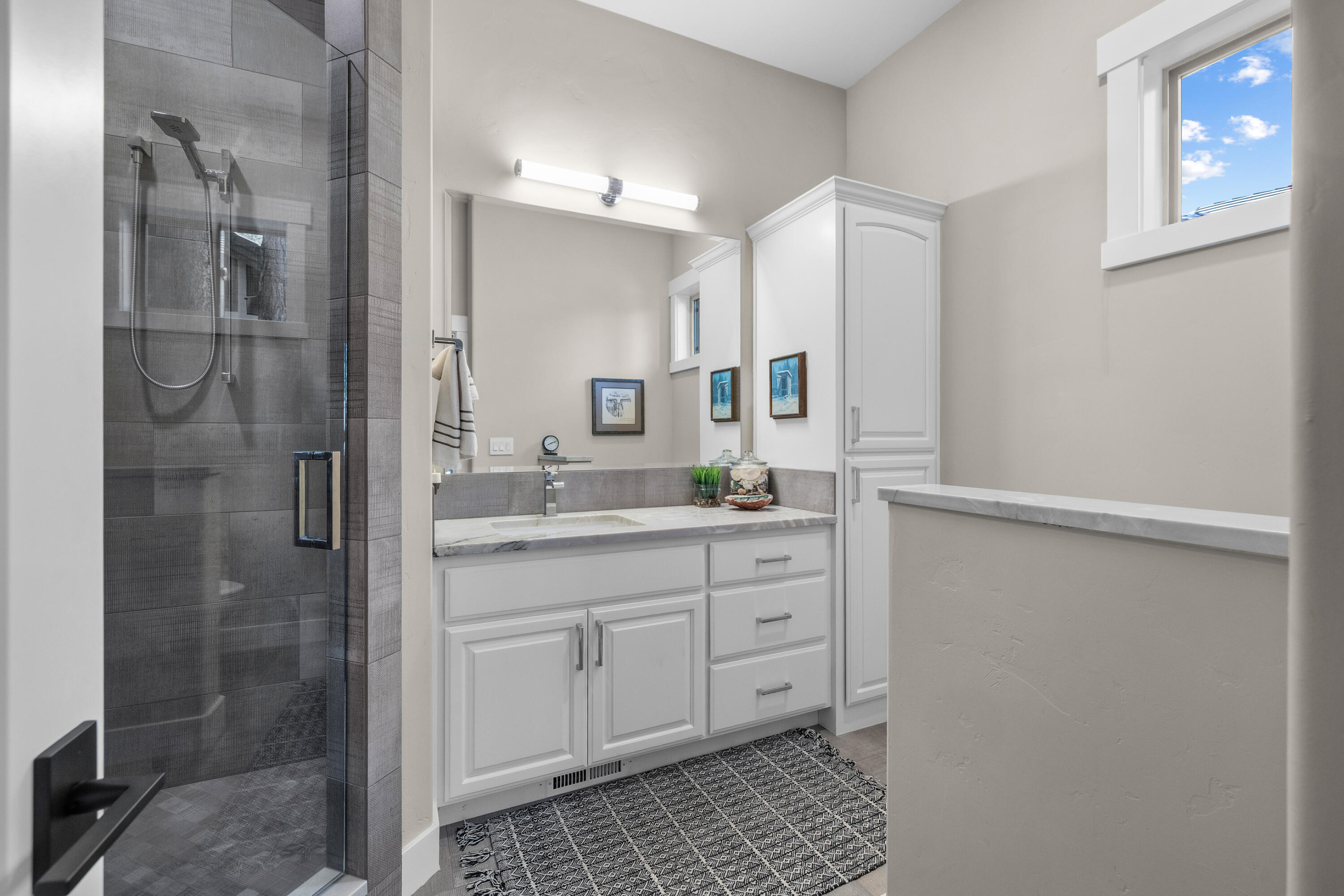 19460 Chip Shot Lane Bend, OR 97702 - Photo 33 of 56 a bathroom with a shower sink and mirror