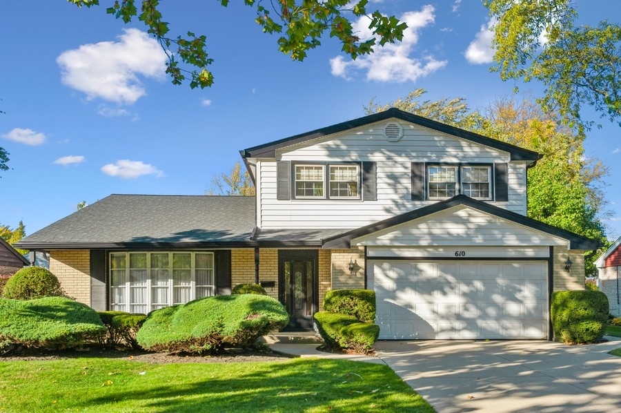 610 East Burr Oak Drive Arlington Heights, IL 60004 - Photo 1 of 1 a front view of a house with garden