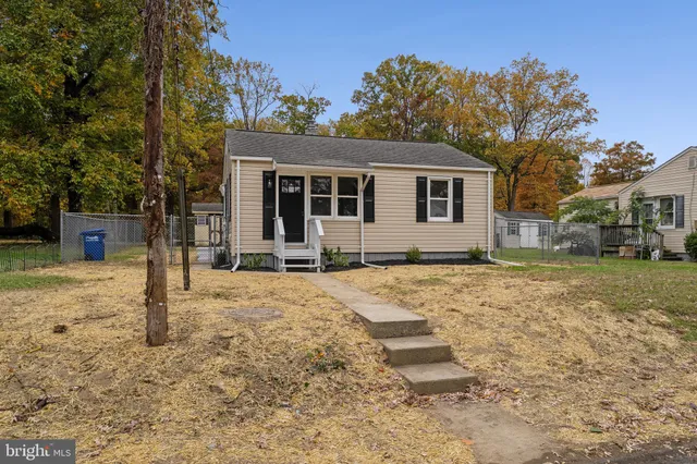 a front view of a house with a yard covered in snow