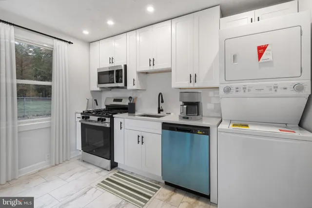 a kitchen with stainless steel appliances granite countertop a stove and a refrigerator
