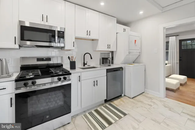 a kitchen with a sink stove and microwave