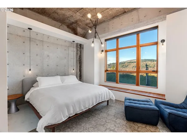 a bedroom with furniture and a window