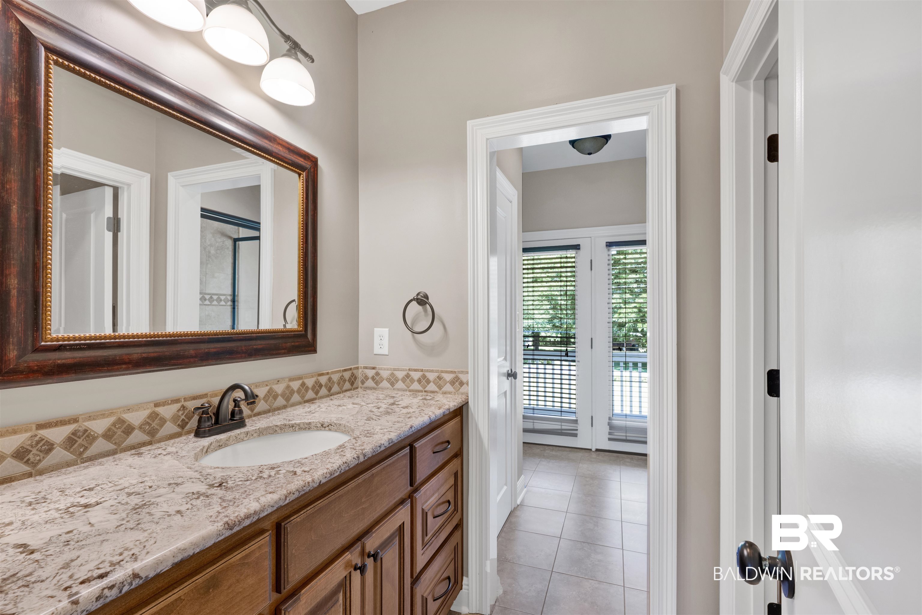12944 Anna's Way Stapleton, AL 36578 - Photo 61 of 64 Vanity with wood cabinetry, light-toned countertop, and undermount sink