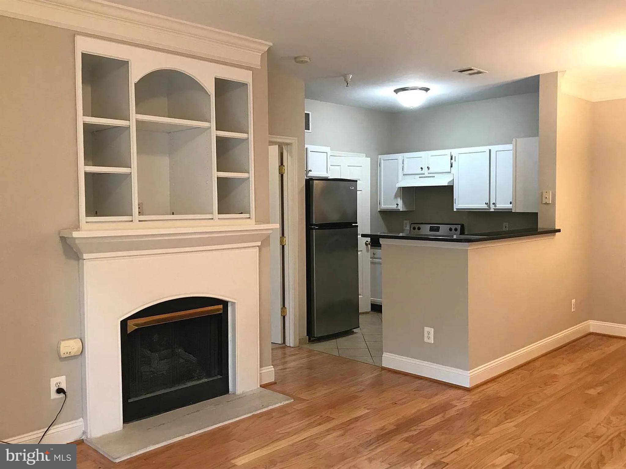 1580 Spring Gate Dr., Unit 4314 McLean, VA 22102 - Photo 8 of 36 a view of a livingroom with a fireplace and television