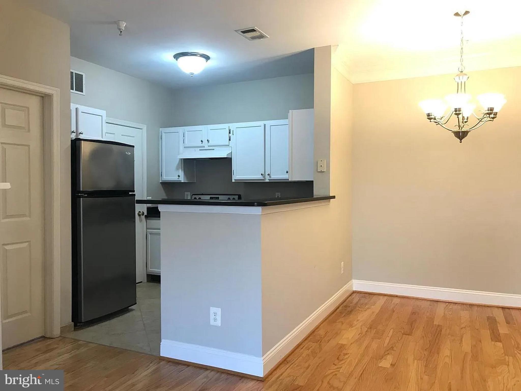 1580 Spring Gate Dr., Unit 4314 McLean, VA 22102 - Photo 9 of 36 a kitchen with granite countertop a refrigerator and a sink