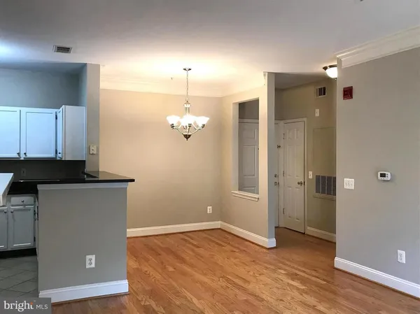 a view of a kitchen with a sink and dishwasher a refrigerator with wooden floor