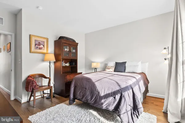 a bedroom with a bed a table and chair