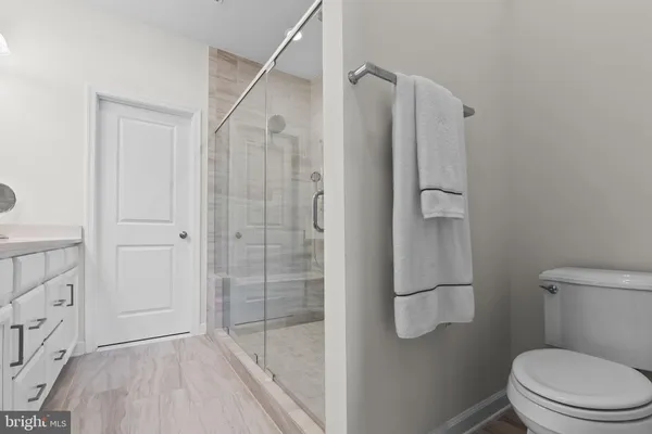 a bathroom with a shower a toilet and sink