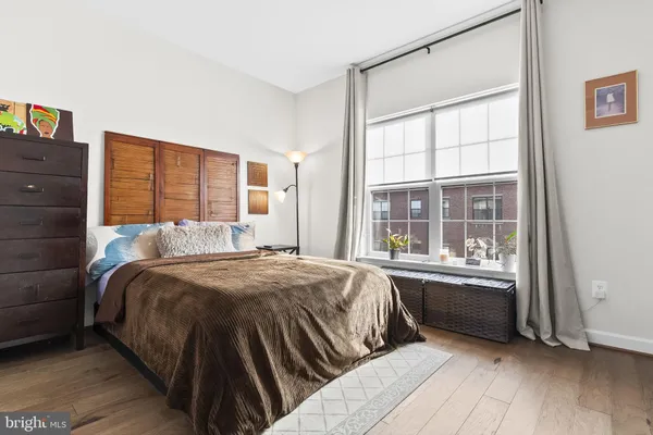 a bed sitting in a bedroom next to a window