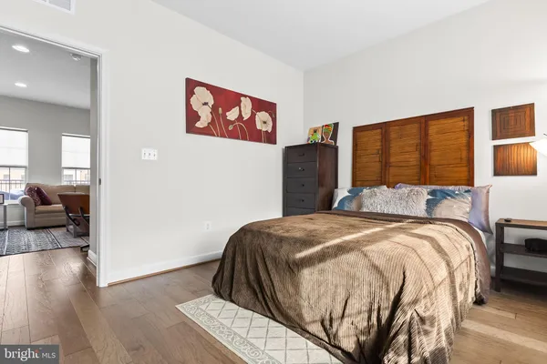 a bedroom with a bed and wooden floor