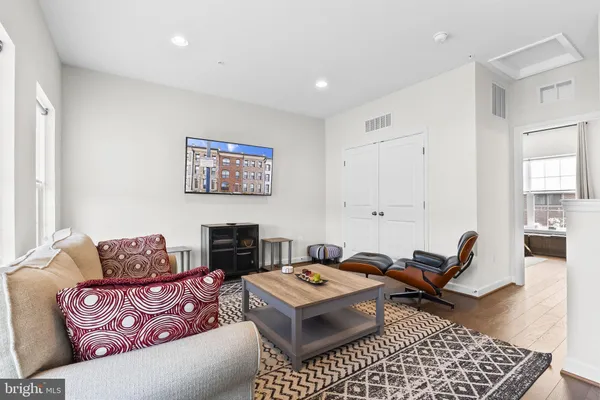 a living room with furniture rug and window
