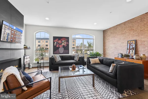 a living room with furniture fireplace and window