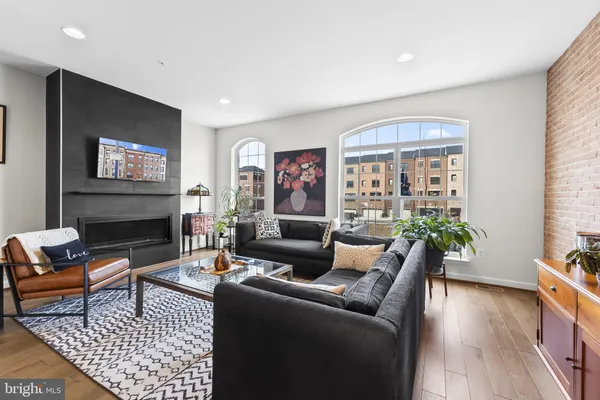 a living room with furniture a fireplace and a flat screen tv