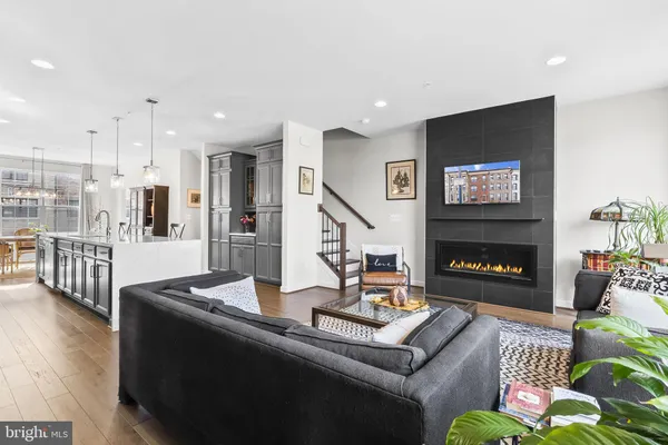 a living room with fireplace furniture and a flat screen tv