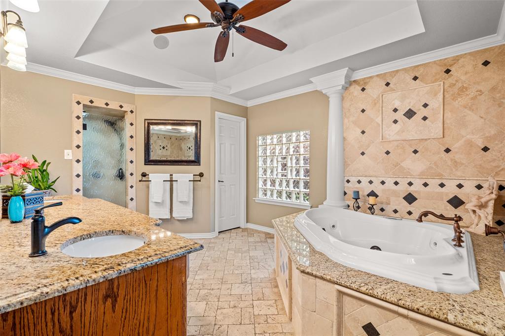 400 Hunters Ridge Circle Coppell, TX 75019 - Photo 16 of 35 a bathroom with a granite countertop sink a mirror and shower