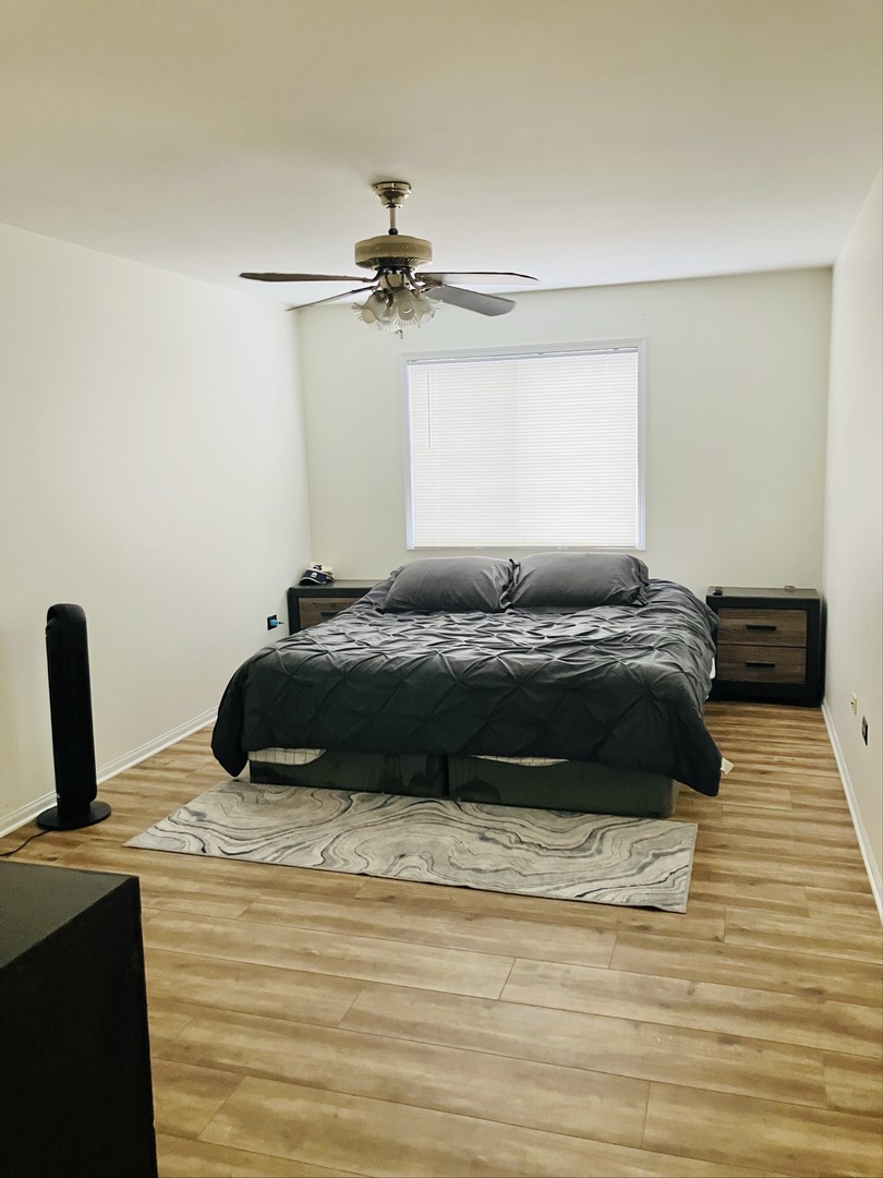 3524 Willowview Court Aurora, IL 60504 - Photo 9 of 12 a bedroom with a bed and a ceiling fan