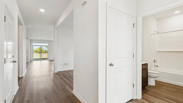 a view of hallway with wooden floor