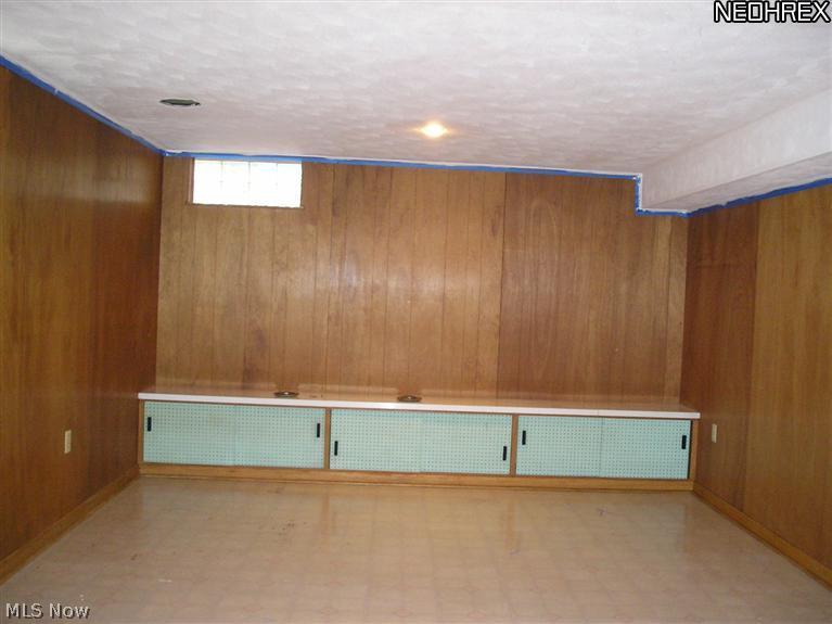 398 Herbert Road Akron, OH 44312 - Photo 22 of 25 Lower Level Recrecation Room with Storage Area and Glass Block Window. Square Footage of Home Does not Include Finished Recreation Room.
