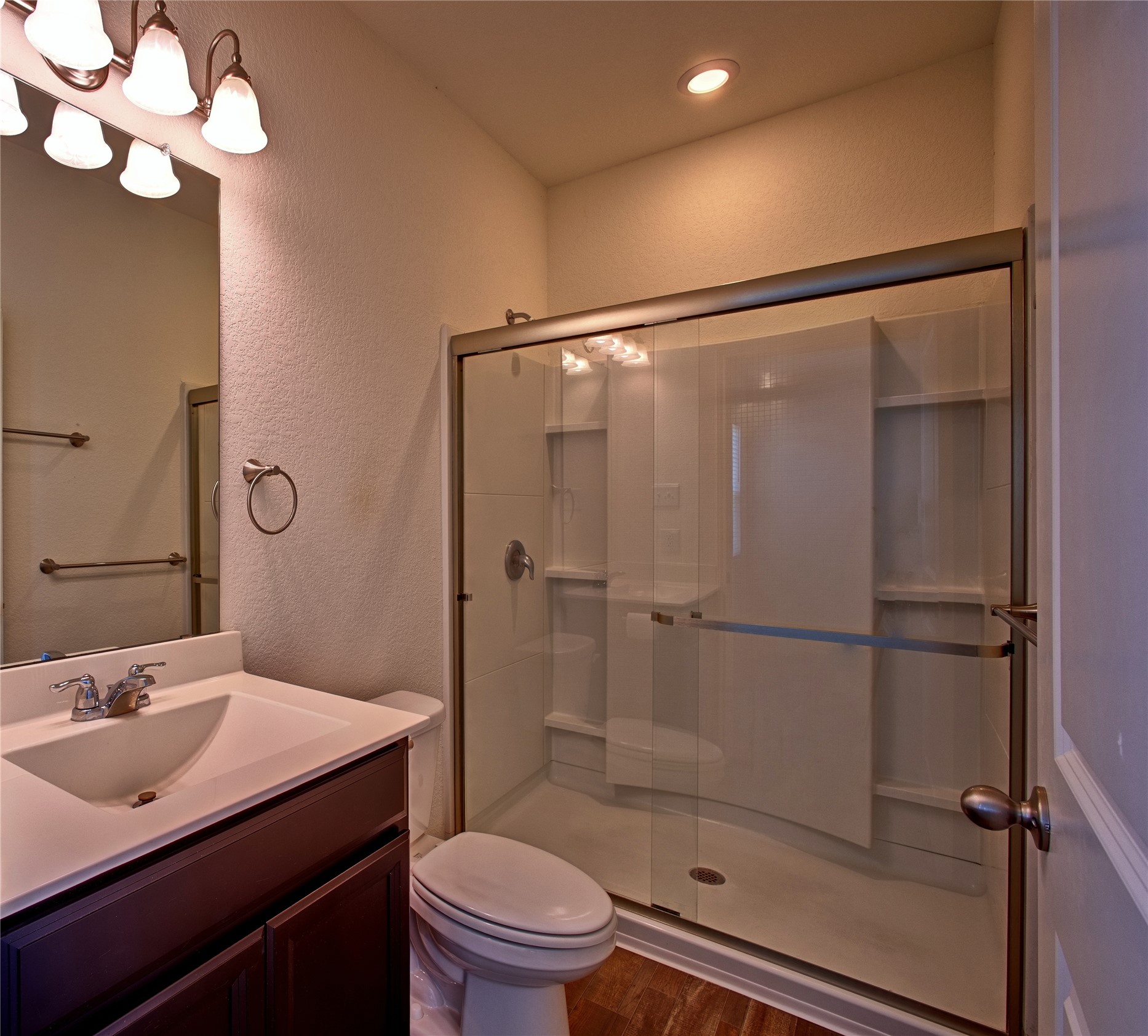 125 Woodpecker Run Jarrell, TX 76537 - Photo 14 of 22 a bathroom with a sink vanity mirror and toilet