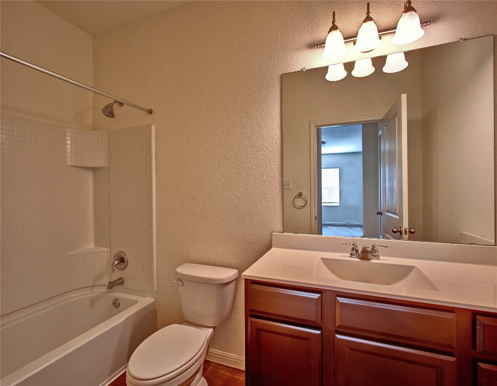 125 Woodpecker Run Jarrell, TX 76537 - Photo 17 of 22 Bathroom with a textured wall, bathtub / shower combination, and vanity