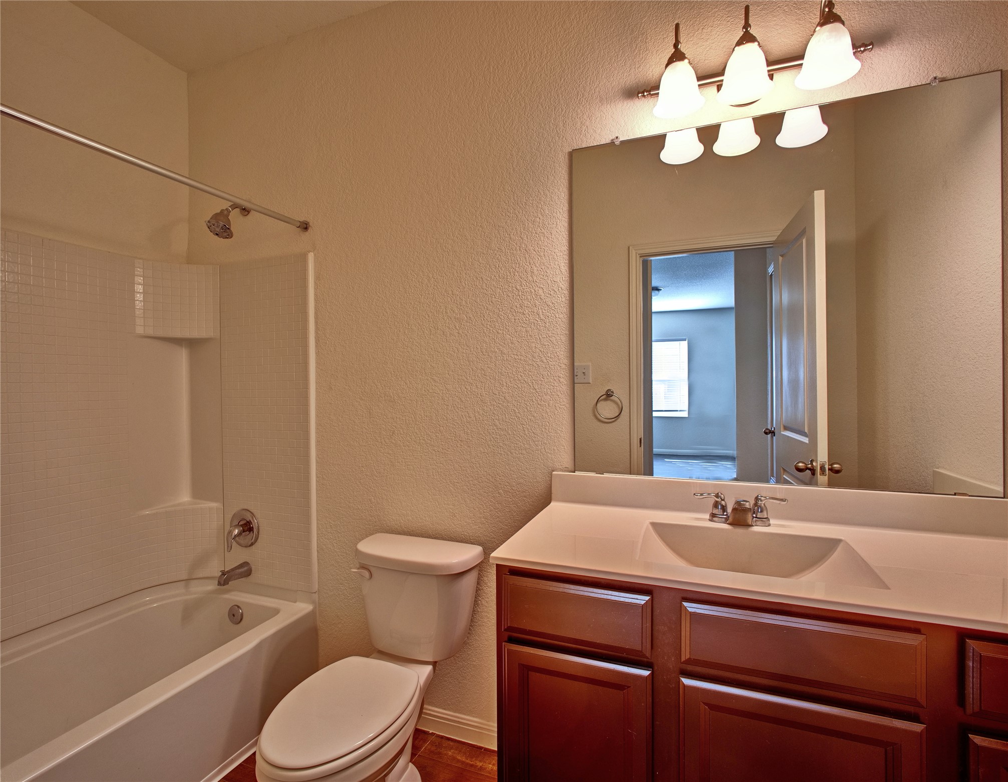 125 Woodpecker Run Jarrell, TX 76537 - Photo 17 of 22 a bathroom with a sink a toilet a mirror and shower