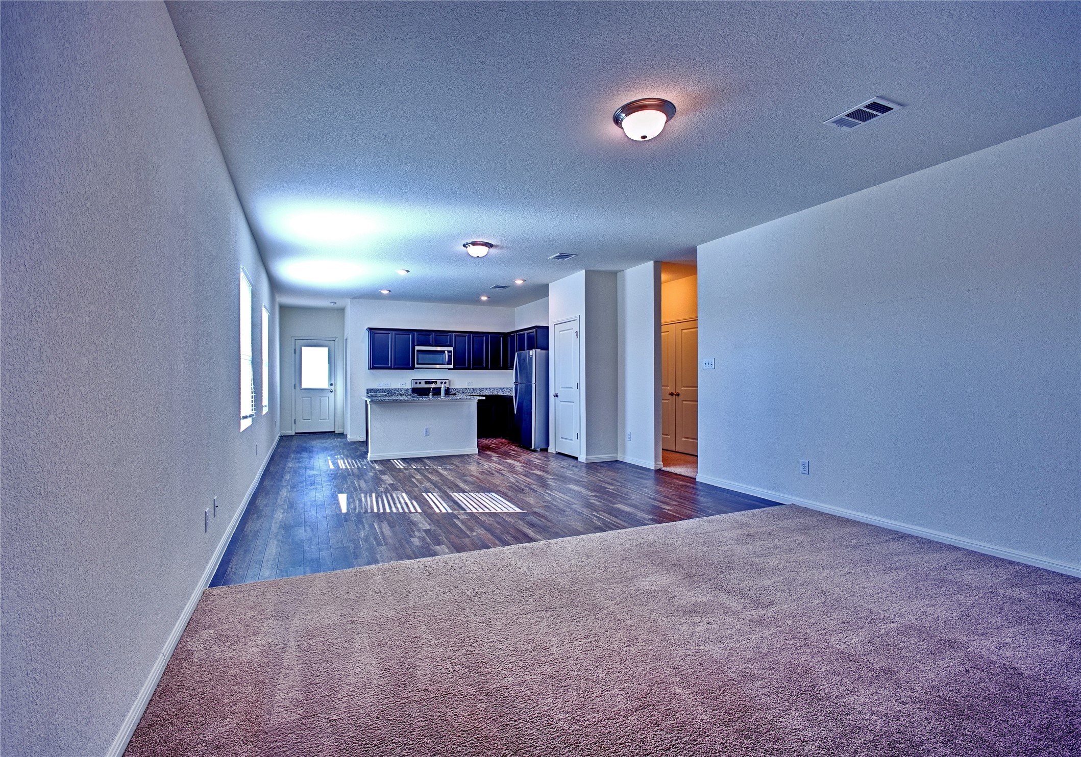 125 Woodpecker Run Jarrell, TX 76537 - Photo 4 of 22 a view of empty room with a kitchen and fireplace