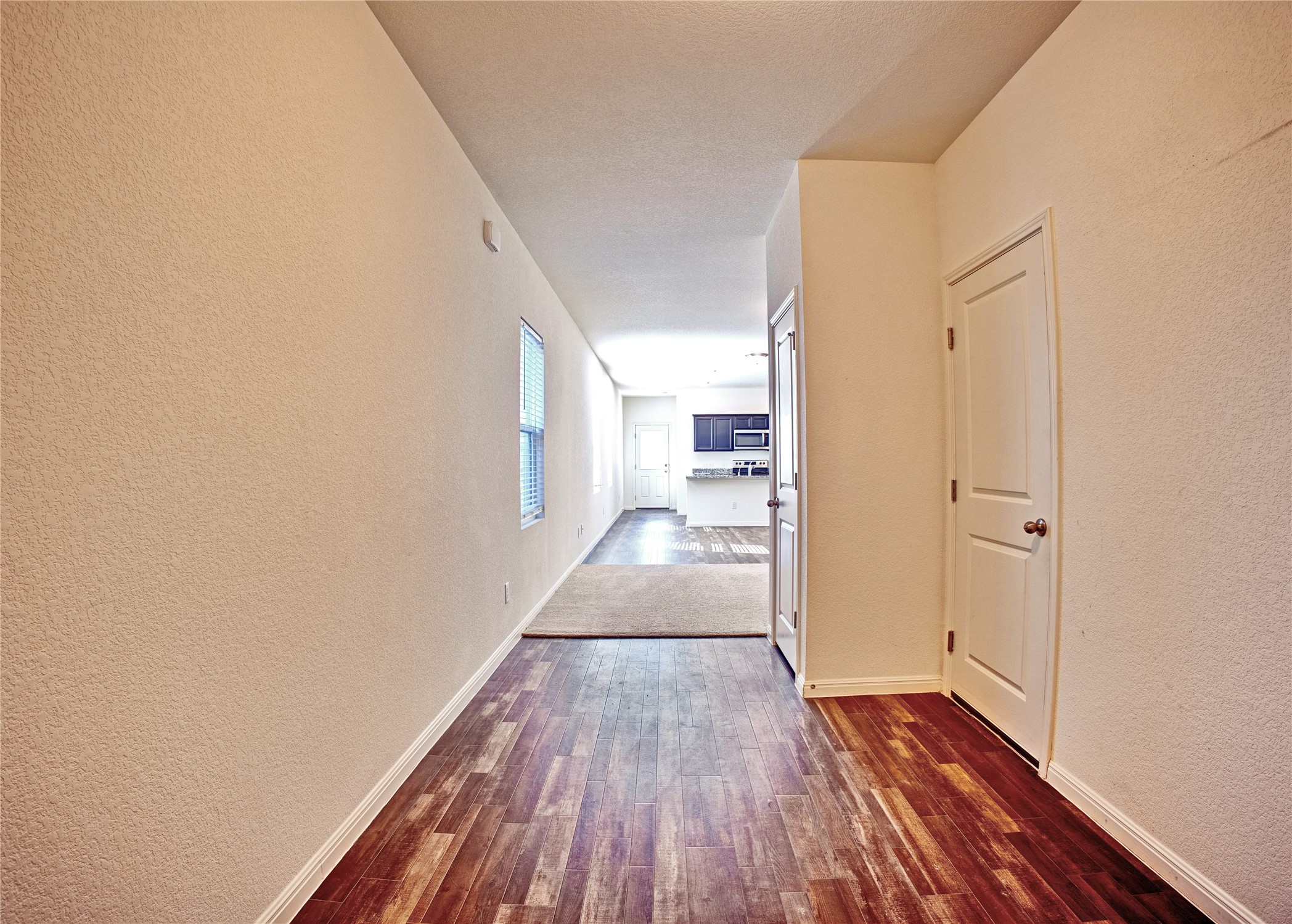 125 Woodpecker Run Jarrell, TX 76537 - Photo 5 of 22 a view of a hallway with wooden floor and staircase