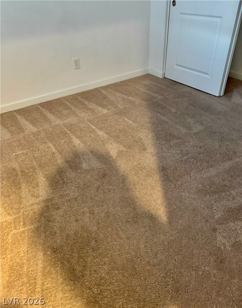 1892 Via Del Rey Court Las Vegas, NV 89115 - Photo 8 of 10 Soft, neutral carpeting creates a comfortable foundation for this inviting room.