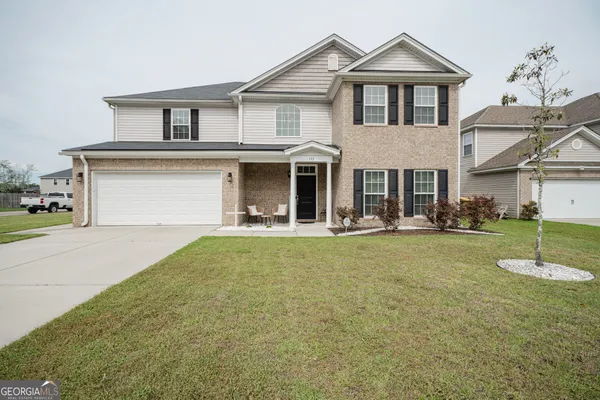 a front view of a house with a yard