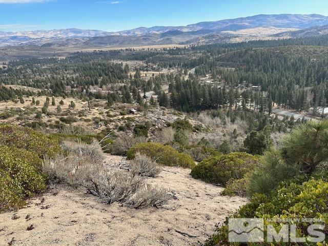 a view of a town with mountains in the background