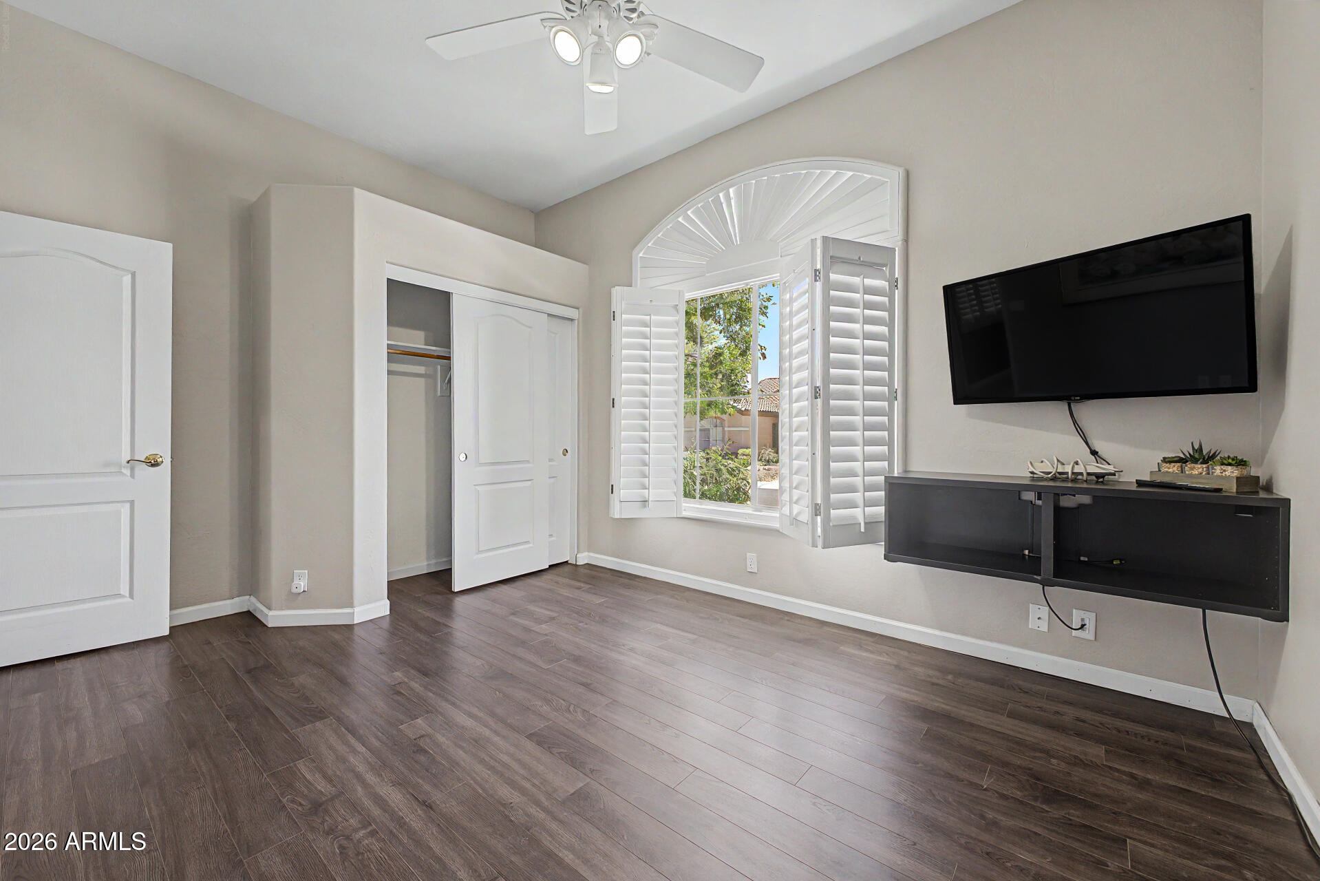 1632 West Frye Road Phoenix, AZ 85045 - Photo 21 of 37 an empty room with wooden floor and windows