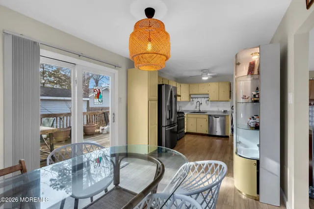 a living room with furniture and a kitchen