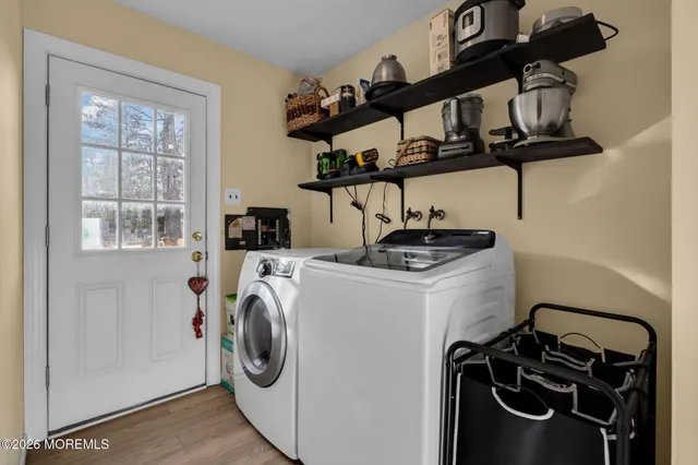 a view of a storage and utility room with washer and dryer