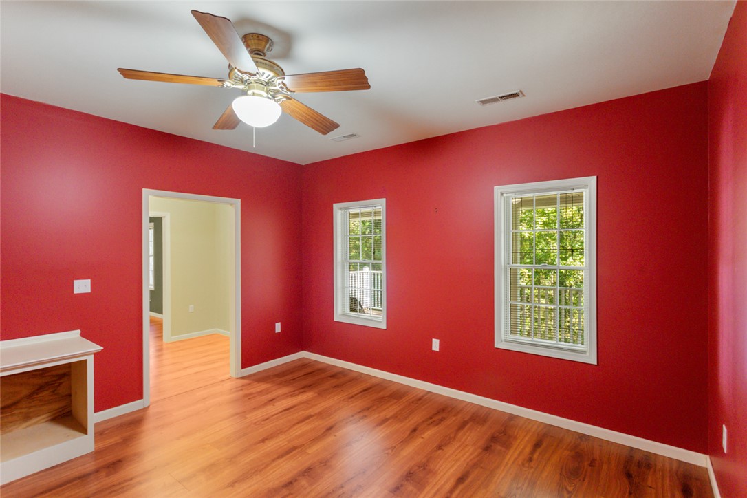 621 Burns Mill Road West Union, SC 29696 - Photo 16 of 45 A vibrant room featuring a ceiling fan and rich wood flooring, ideal for a home office or creative space.