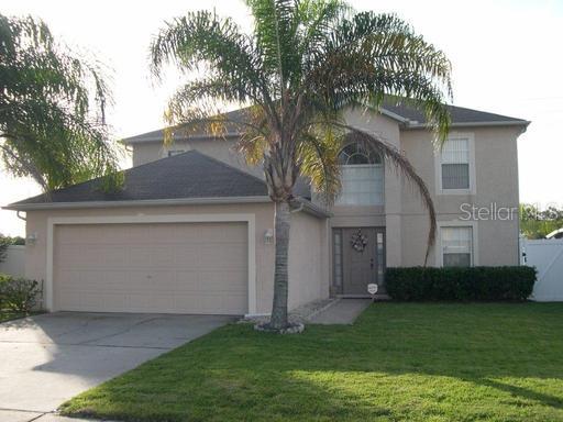11646 Bentry Street Orlando, FL 32824 - Photo 1 of 1 a front view of a house with a garden and a tree