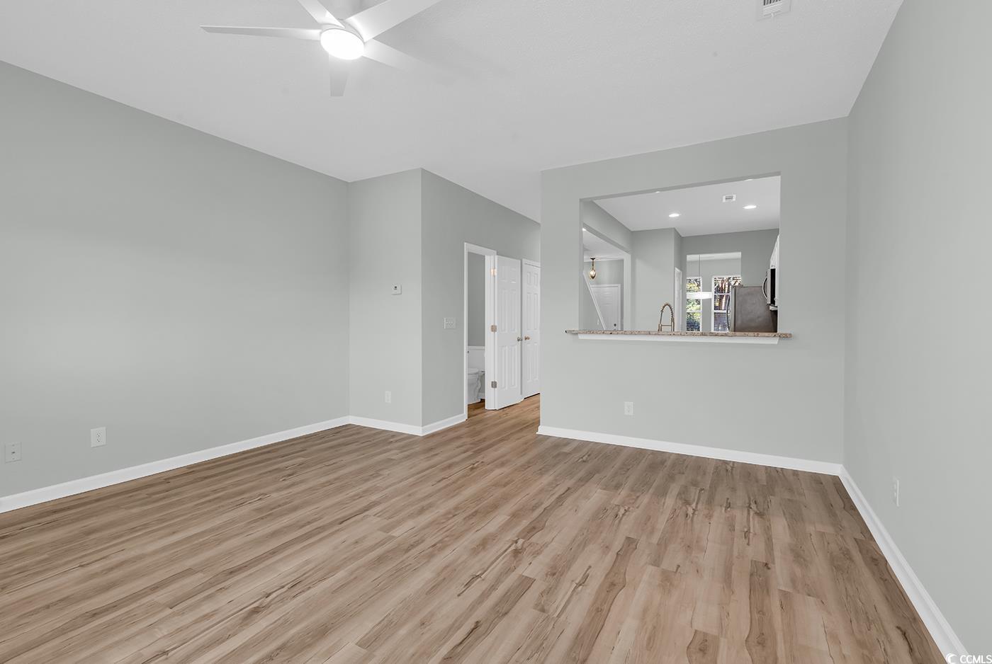 308 Kiskadee Loop, Unit E Conway, SC 29526 - Photo 15 of 36 Unfurnished living room featuring light wood-style floors, a ceiling fan, and recessed lighting