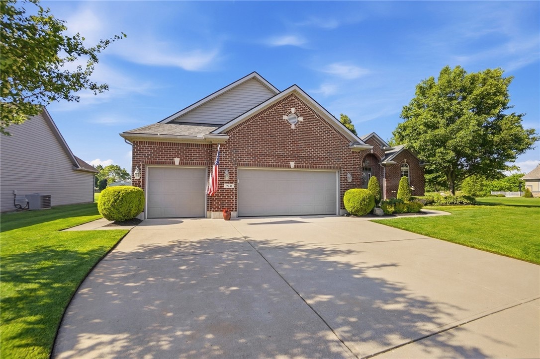 710 Governors Road Troy, OH 45373 - Photo 4 of 56 This classic brick residence features an attached garage and a well-manicured lawn.