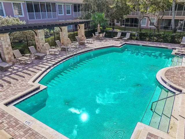 a living room with furniture and a book shelf