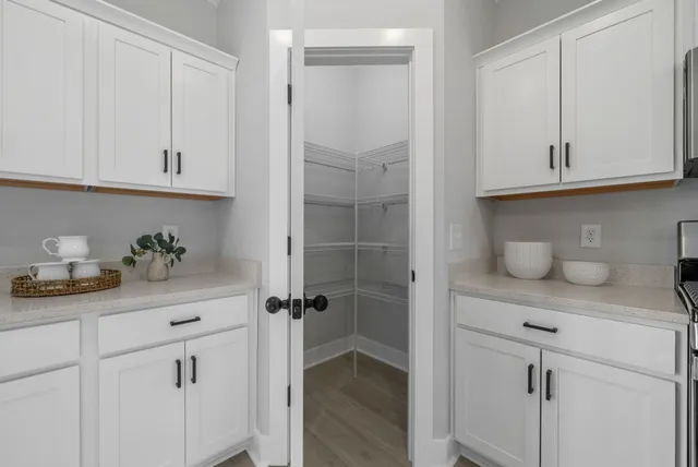 a kitchen with cabinets and a window