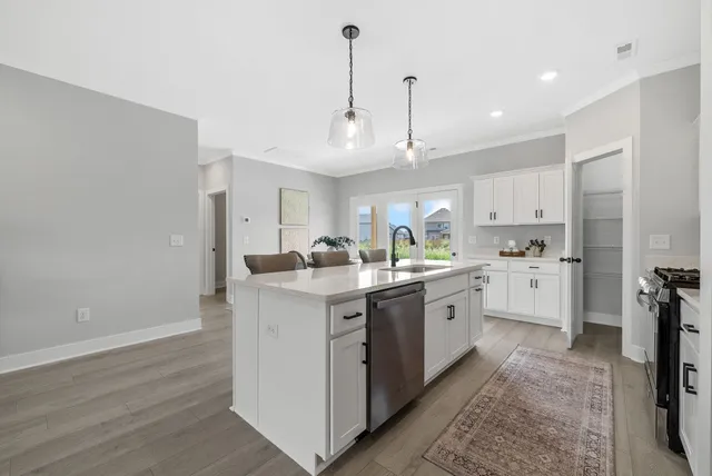 a kitchen with white cabinets and white appliances