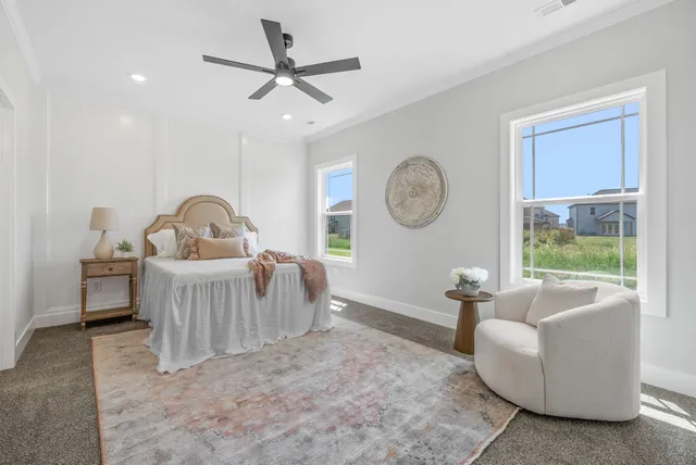 a living room with furniture a window and a clock